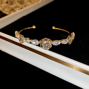Detail of 14k gold plated flower bracelet with marquise-cut zircon in a luxury jewelry box