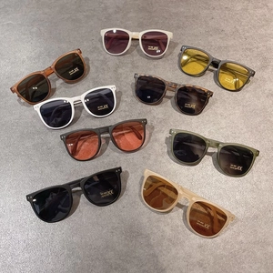 Foldable kids sunglasses in assorted colors with UV400 protection on stone surface