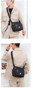 Close-up of waterproof black crossbody bag with multiple zippers and mesh side pocket