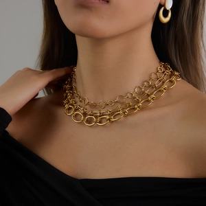 Détail de colliers multicouches en acier inoxydable plaqué or 18 carats sur un mannequin