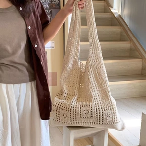 Detail of hollow-out crochet knit tote bag with geometric patterns and soft texture
