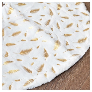 Detailed texture of white plush Christmas tree skirt with golden feather foil patterns