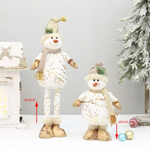 Detail of telescopic snowman dolls with gold leaf fabric and retractable leg feature
