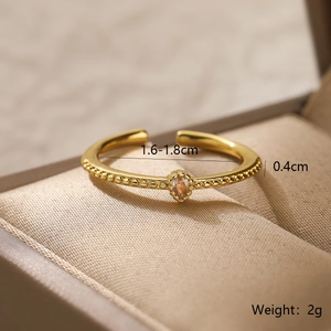 Detailed view of an 18K gold plated open ring with sparkling zircon in a jewelry box