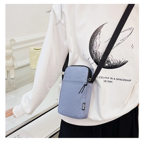 Blue nylon crossbody phone bag with SPORT label and black shoulder strap for daily travel