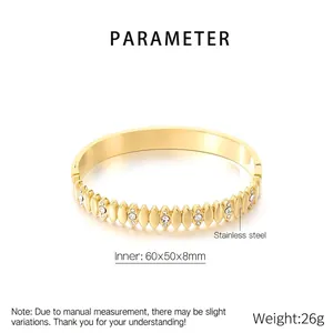 Detailed view of gold plated stainless steel oval bangle with sparkling marquise zircons
