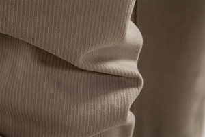 Macro shot of thick ribbed fabric texture on khaki casual business pants for men