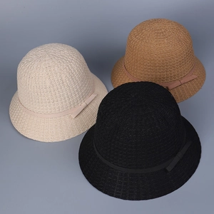 Close-up of breathable knit bucket hats with ribbon bows in beige, brown, and black