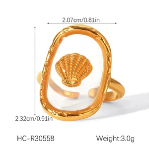 Detail view of gold stainless steel shell ring with product weight and dimensions
