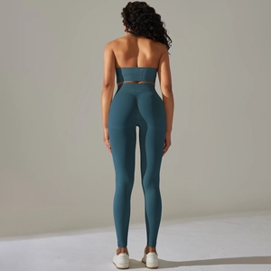 Back view of dark teal ribbed yoga set showing high-waist leggings and sports bra fit