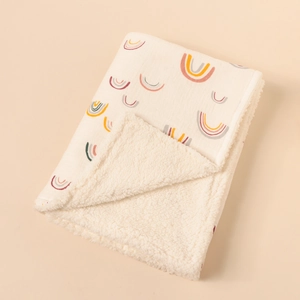 Detailed view of rainbow print cotton blanket with thick sherpa fleece lining for warmth
