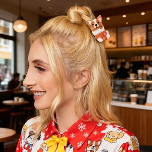 Side view of a plush Corgi dog hair claw clip with snowflake patterns on a model