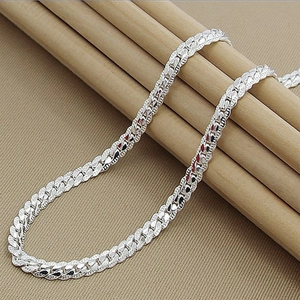 Sleek silver 5mm curb link chain necklace displayed on rustic wood and beige texture