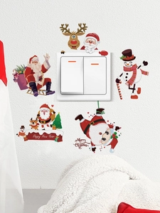 Close-up of Santa Claus and reindeer wall stickers around a light switch on a white wall
