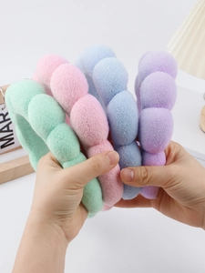 Set of four pastel bubble headbands in green, pink, blue, and purple plush fabric