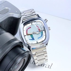 Macro detail of retro men's silver quartz watch with colorful artistic dial pattern