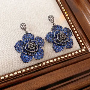 Vintage blue zircon flower earrings with dark metal finish and drop design