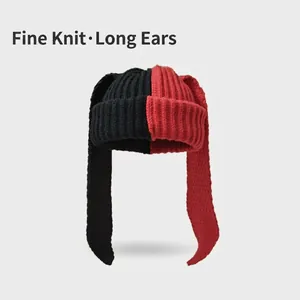 Detailed view of the tight-knit texture on the red and black long-ear beanie hat