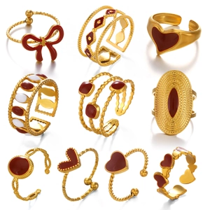 Set of 9 gold-plated minimalist open rings featuring red heart and bow enamel designs