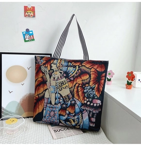 Close-up of artistic tapestry tote bag with Egyptian motifs and striped handles