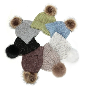 Women's cable knit beanie with pom-pom in multiple colors for winter outdoor warmth
