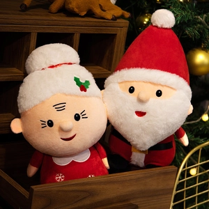 Christmas Santa and Mrs. Claus plush dolls set in a warm festive holiday setting