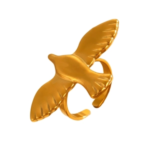 Detailed close-up of golden flying bird ring featuring intricate wing textures and an open band