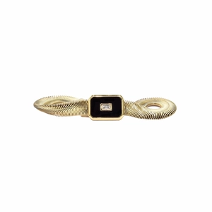 Close-up of gold snake chain bracelet featuring black rectangular shell charm detail
