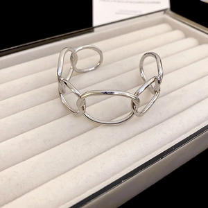 Close-up of polished silver chunky chain cuff bracelet with oval interlocking links