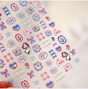 Macro view of 5D embossed nail stickers M-1179 with cartoon cat and tulip designs