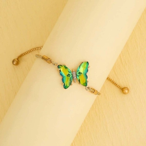Adjustable gold butterfly bracelet with gradient green crystal and bolo drawstring closure