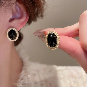 Retro golden oval earrings with black resin inlay and classic twisted metal frame for women