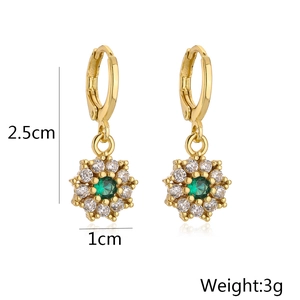 Detailed view of 18K gold flower earrings with green stones showing size 2.5cm height