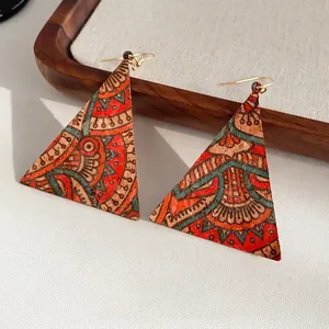 Bohemian geometric triangle leather earrings with vintage tribal print on wood tray