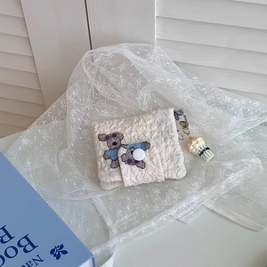 Quilted floral coin purse with cute animal embroidery and popcorn charm detail