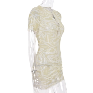 Detail of yellow and white marble print mini dress with cutout bust and button accents