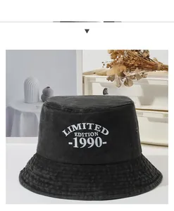 Detail shot of black washed cotton bucket hat with white 1990 Limited Edition embroidery