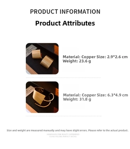 Detail view of gold-plated brushed metal jewelry set with open cuff and earrings