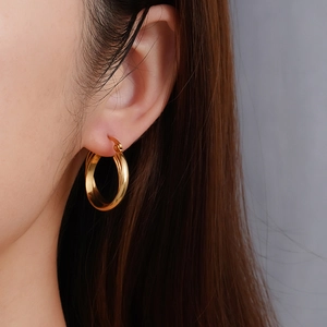 French vintage style 18K gold plated stainless steel hoop earrings worn by a model