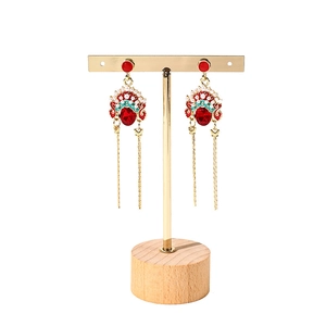 Traditional Peking Opera mask tassel earrings on a wooden base jewelry display stand