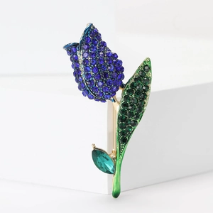 Detailed close-up of tulip brooch featuring blue rhinestones and green enamel foliage