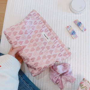 Pink heart jacquard makeup bag with simple wish label on a white quilted background