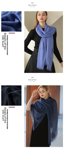 Close-up of lightweight pleated scarf with delicate fringe edges in blue and navy tones
