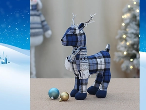 Detailed view of blue plaid fabric Christmas reindeer figurine with warm festive lighting