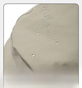 Macro detail of waterproof khaki bucket hat fabric showing water droplets on surface