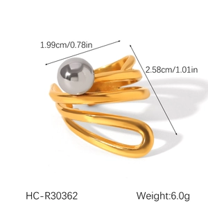 Detail view of gold spiral mixed ring with size dimensions and a grey spherical bead