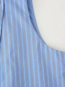 Detailed close-up of blue and white striped cotton fabric with high-quality texture