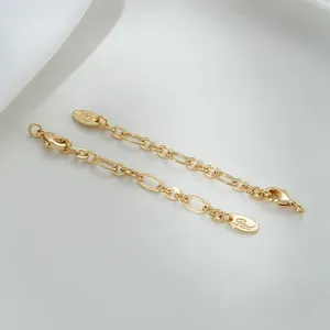 Macro detail of 14K gold filled lobster clasp with oval tag and extension chain