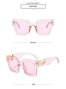 Detail view of pink square sunglasses featuring golden W metal decoration on the temples