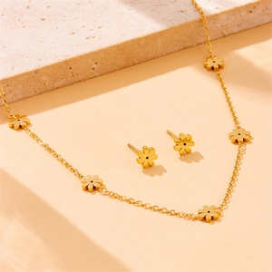 Polished gold flower jewelry set featuring a delicate daisy necklace and matching stud earrings